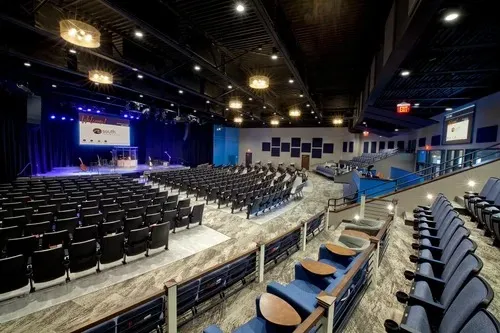 Large Auditorium/Event Hall with Tiered Theatre Seating Auditorium/Event Hall Design Desk and Decor 