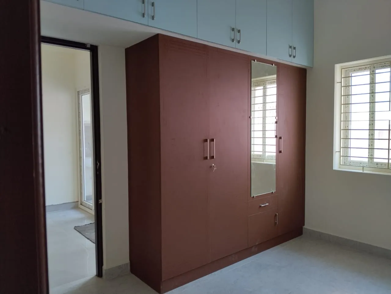 Four-Door Matte Brown Wardrobe with Integrated Pastel Blue Loft Storage | Wardrobes Interior Design by Desk & Decor