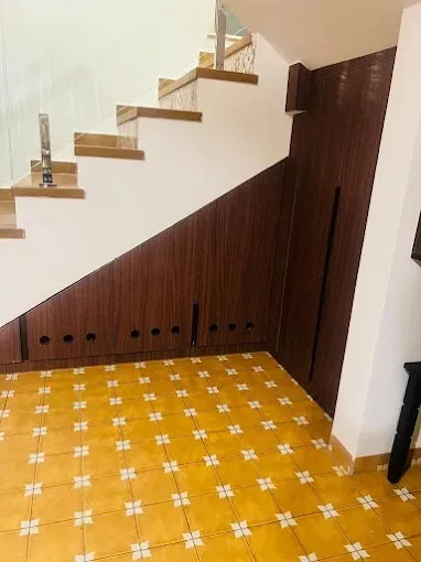 Under-Stair Storage Unit with Wooden Paneling