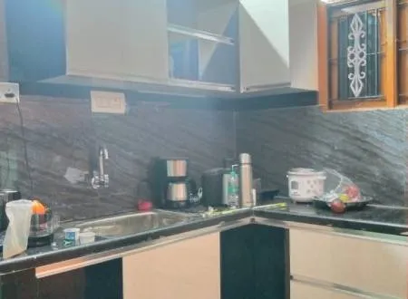 Compact Kitchen with Black Granite Backsplash