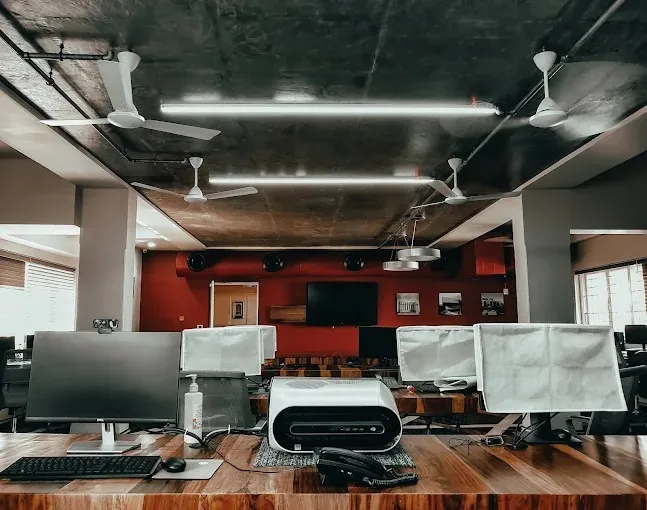Industrial-Style Open Office Workspace with Open Workspace Offices Desk and Decor