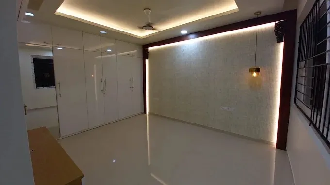 Bedroom with Glossy White Wardrobe & Backlit Feature Wall